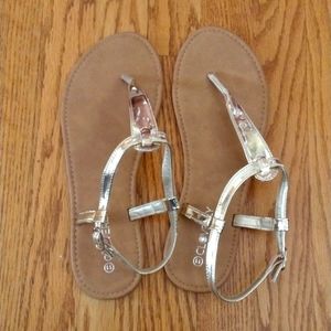 Gold Shiny T Strap Sandals from Cloverly